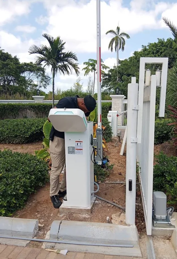 Technician installing an outdoor entry access control system