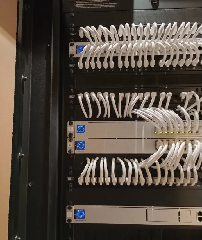 Tidy white network patch cables arranged in an equipment rack