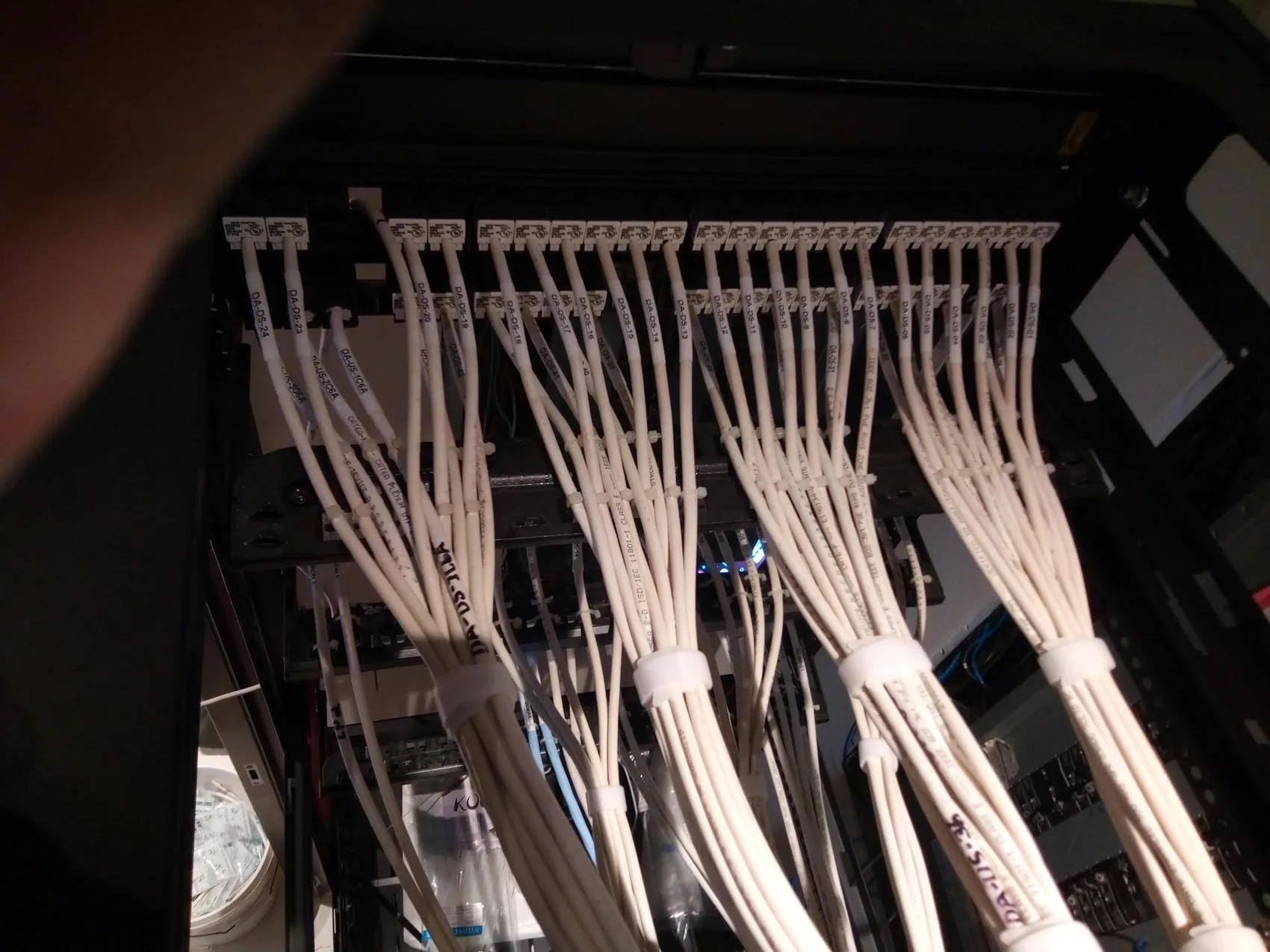 White structured cabling carefully organized inside an equipment rack