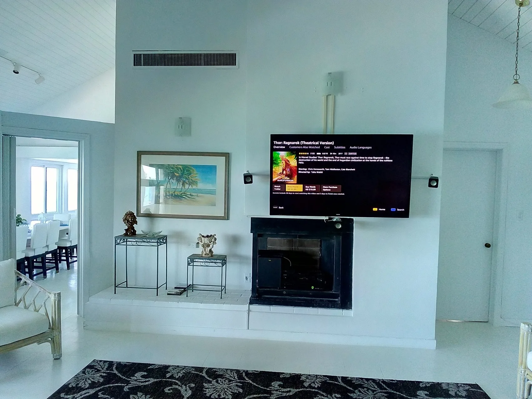 Completed living room with a wall-mounted television and concealed equipment