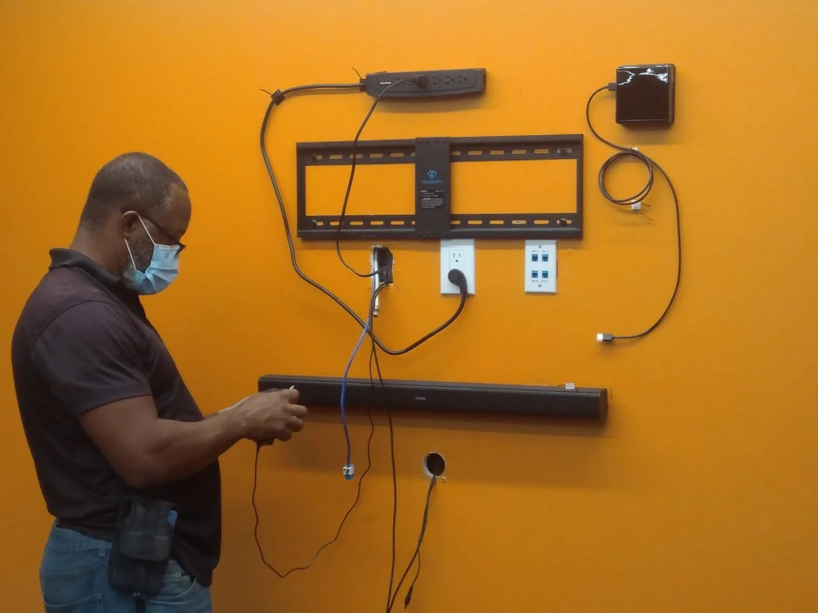 Technician configuring an audiovisual system during installation